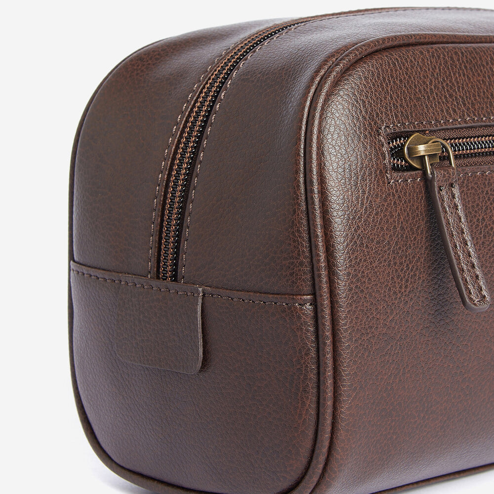 Barbour LEATHER Mens Wash Bag Dark Brown side view showcasing the zip closure and natural grained finish.