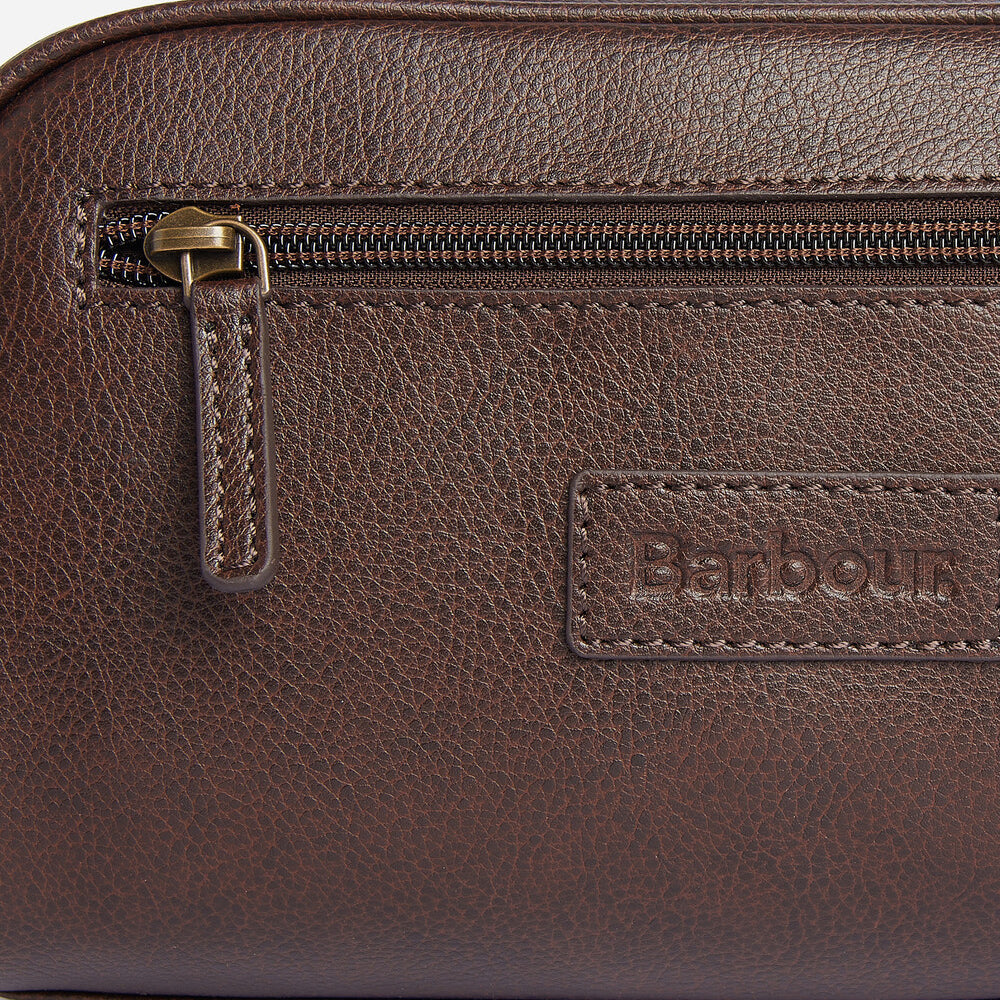 Close-up detail view of Barbour LEATHER Mens Wash Bag Dark Brown showing embossed logo and zip.