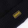 Barbour SWEEPER LEGACY Mens Beanie Black detail view featuring ribbed texture and silicone logo badge.