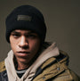 Barbour FLEX Mens Beanie Black worn by a model, front view showcasing the beanie's design and branding.