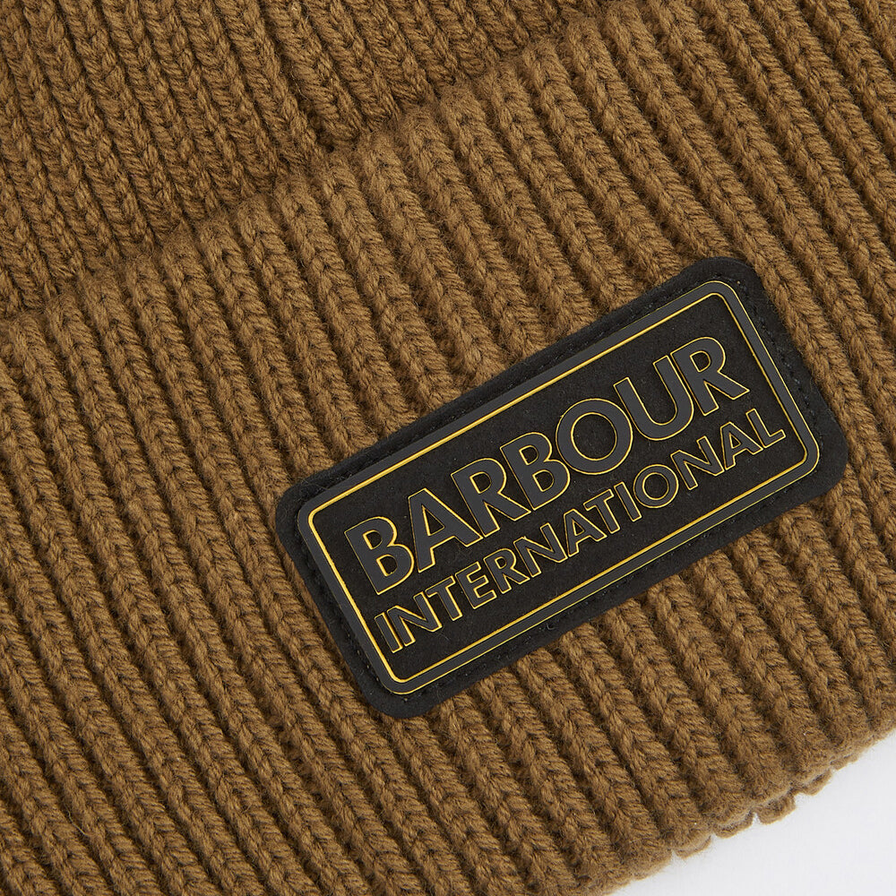 Barbour FLEX Mens Beanie Military Olive detail view showing rubberised branded badge on outer.