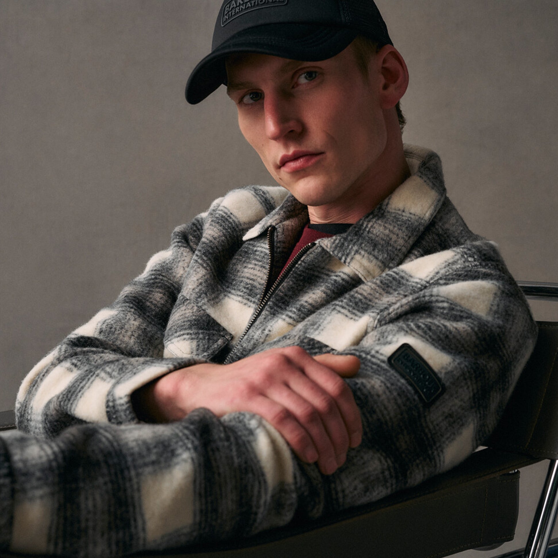 Barbour ALBURY Mens Sports Cap Black front view with model wearing a grey checkered jacket.
