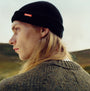 Barbour MOSELY Mens Fisherman Beanie Black side view on model showcasing detail of the hat and removable Barbour pin.