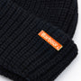 Barbour MOSELY Mens Fisherman Beanie Black detail view showing removable metal logo pin on cuff