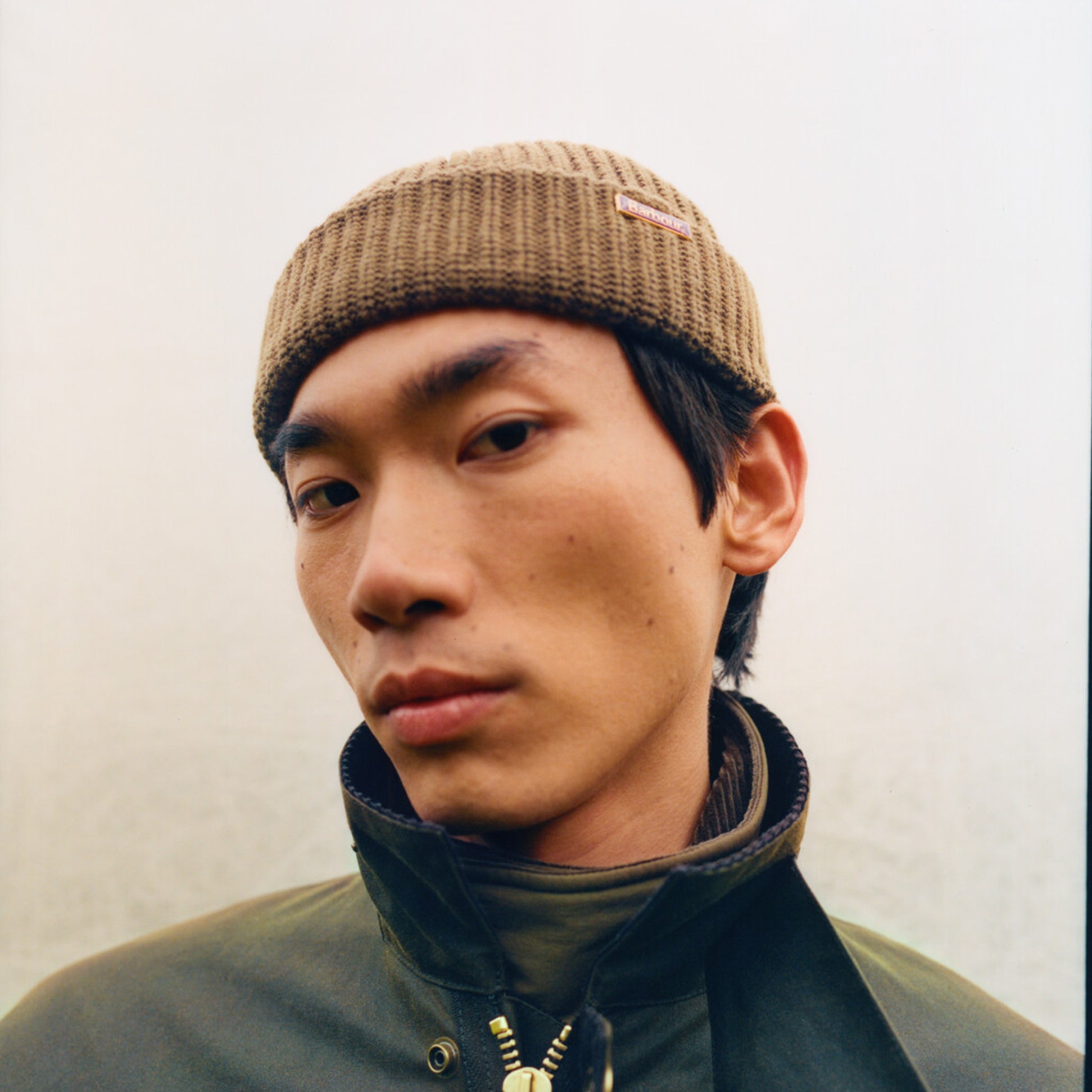 Barbour MOSELY Mens Fisherman Beanie Light Sage front view worn by a man with a neutral background.
