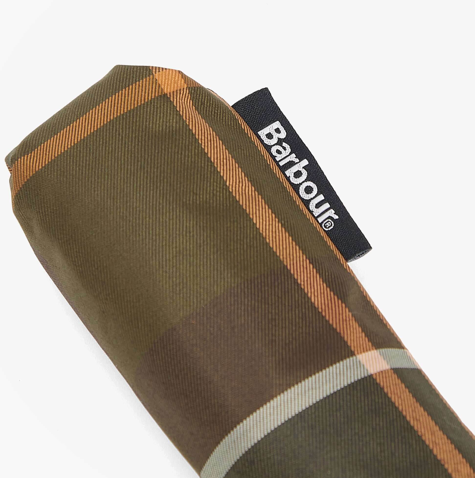 Barbour TARTAN MINI Classic Umbrella detail view showing the folded canopy with woven Barbour label.