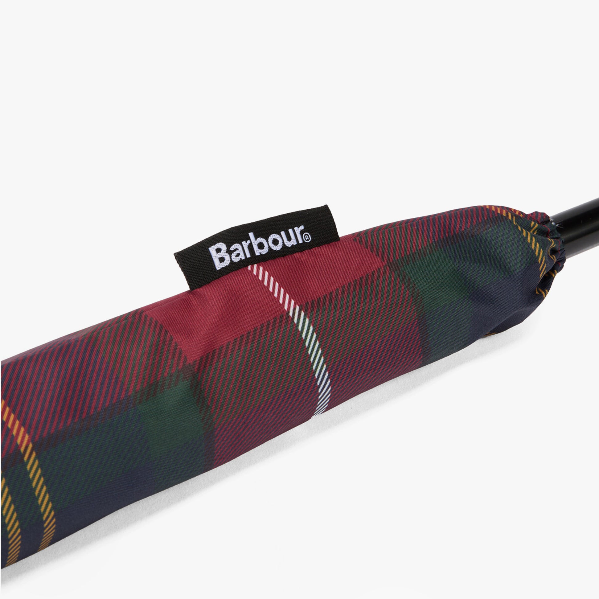 Barbour Tartan Walker Umbrella detail view of the canopy sleeve with woven Barbour side flag label.