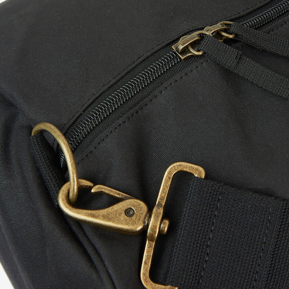 Barbour EXPLORER WAX Unisex Adults Duffle Bag Black detail view of zipper and strap attachment.