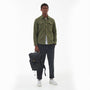 Barbour ESSENTIAL WAX BACKPACK Unisex Adults Backpack Black front view held by a model dressed in casual attire.