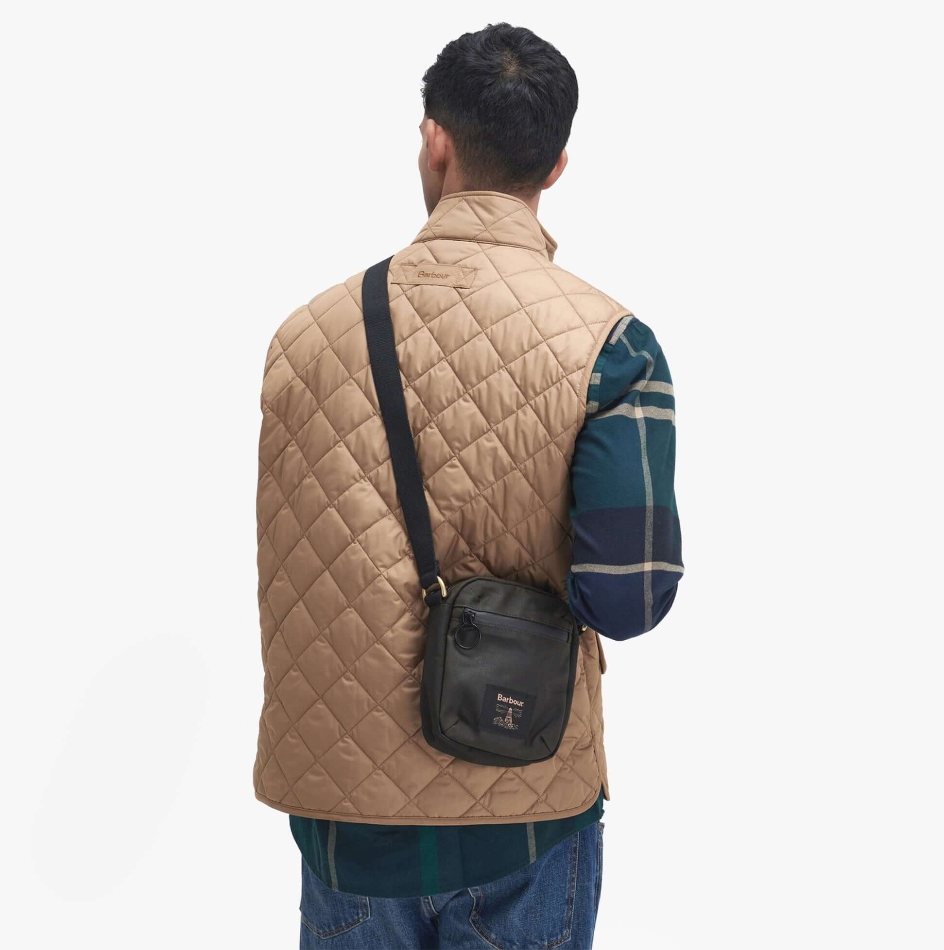 Barbour FIELD WAX Mens Crossbody Bag Olive/Black side view worn by model with quilted vest.
