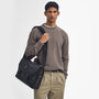 Barbour FIELD WAX Unisex Adults Messenger Bag Black front view on model with adjustable strap and relaxed attire.