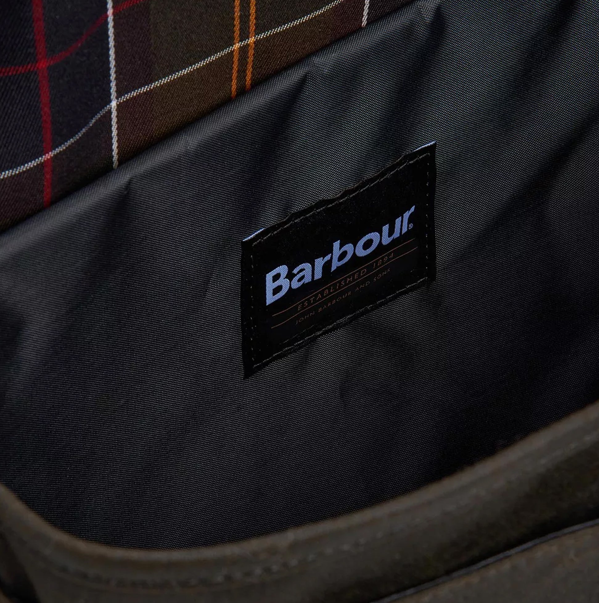 Detail view of Barbour FIELD WAX Unisex Adults Messenger Bag Olive interior, showing brand label and lining.