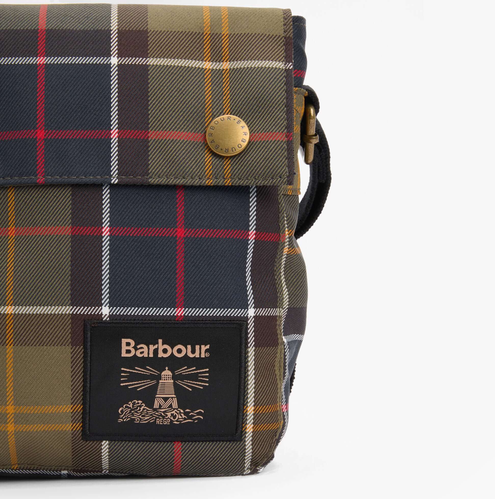 Barbour TORRIDON TARTAN Mens Flight Bag Classic Tartan side view showcasing the button closure and distinctive tartan pattern.