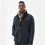 Barbour LAMBSWOOL TATTERSALL Scarf Unisex Adults Forest Mist styled on a model, showcasing a front view with a navy jacket.