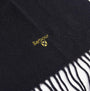 Barbour PLAIN LAMBSWOOL Mens Winter Black detail view of the scarf with logo and fringes.