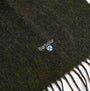 Barbour PLAIN LAMBSWOOL Mens Winter Seaweed detail view of scarf fabric showing logo and texture.