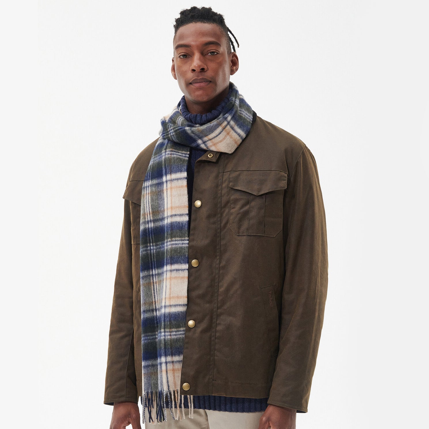 Barbour NEW CHECK Unisex Adults Tartan Scarf Sand Beige Plaid worn by model in front view, featuring checked pattern and tasselled hem.