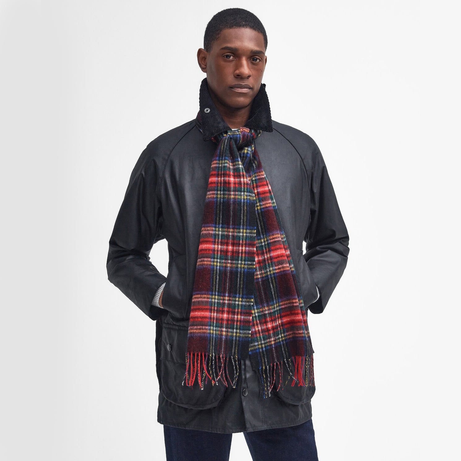 Barbour NEW CHECK Unisex Adults Tartan Scarf Black Stewart worn by model in front view, showcasing the checked pattern and tasselled hem.