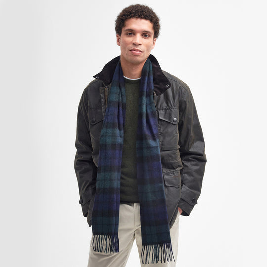 Barbour NEW CHECK Unisex Adults Tartan Scarf Black Watch worn by a model in a stylish outfit with a textured background.