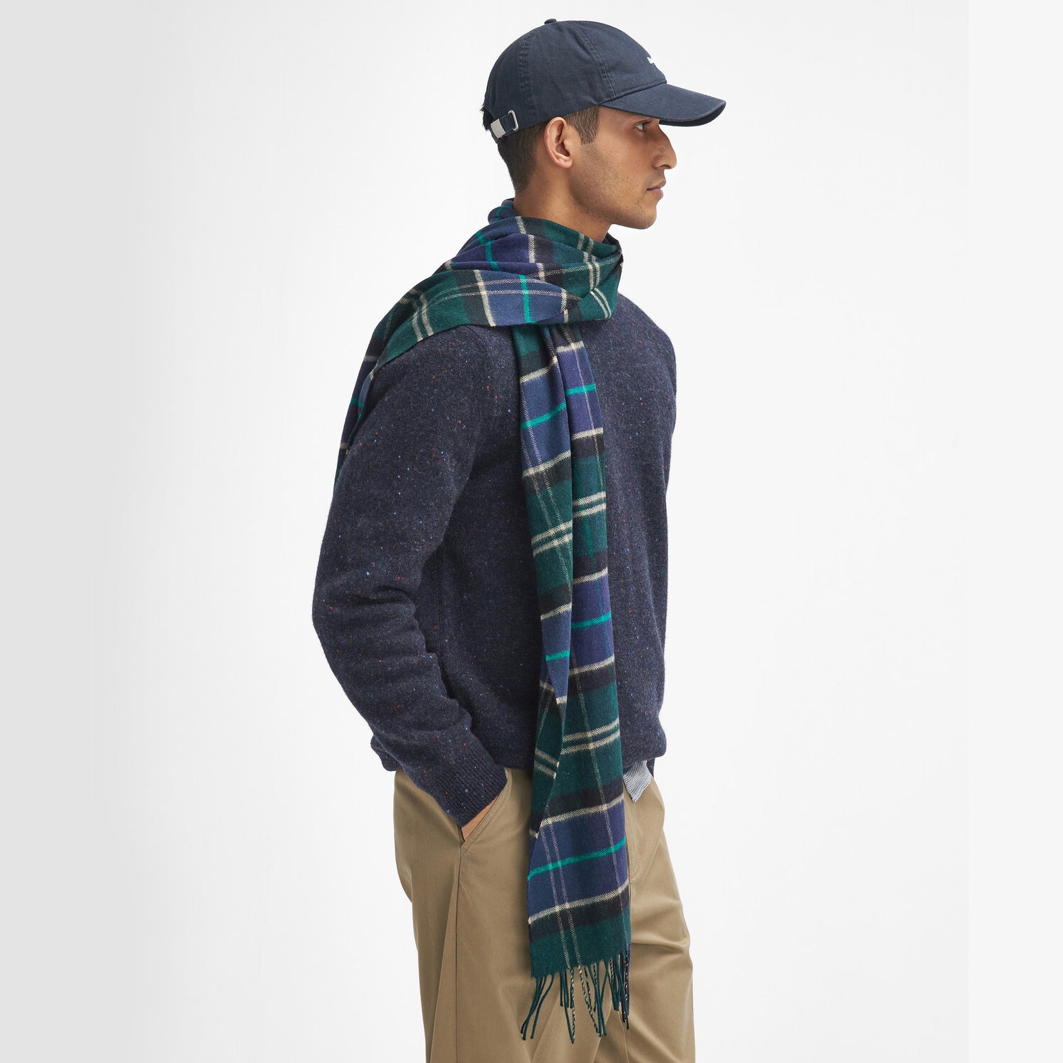 Barbour YAXLEY Unisex Adults Tartan Scarf Green Loch wrapped around a model's neck, side view.
