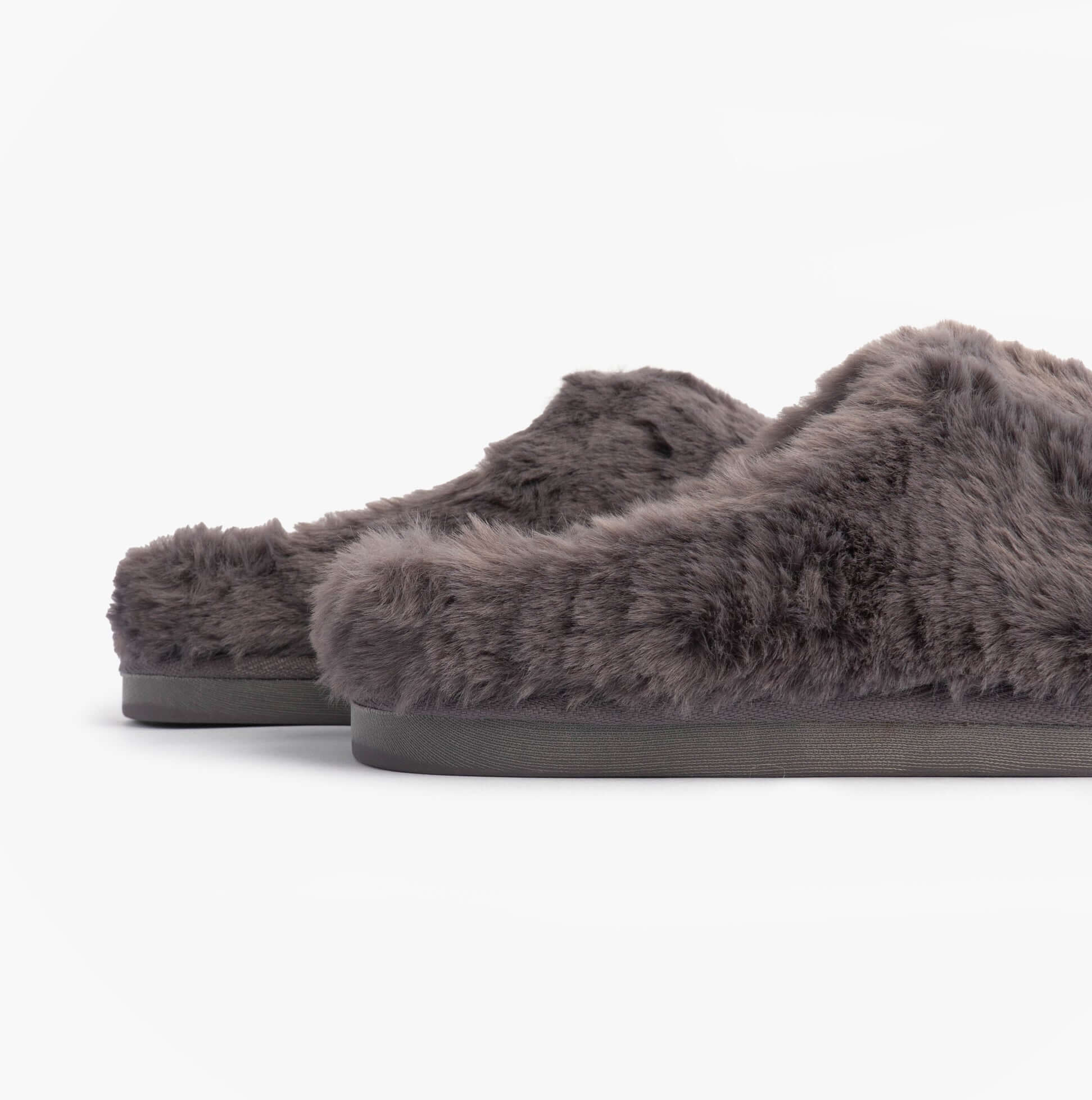 Bedroom Athletics ARIANA Womens Mule Slippers Ink side view showing faux fur upper and flat sole.