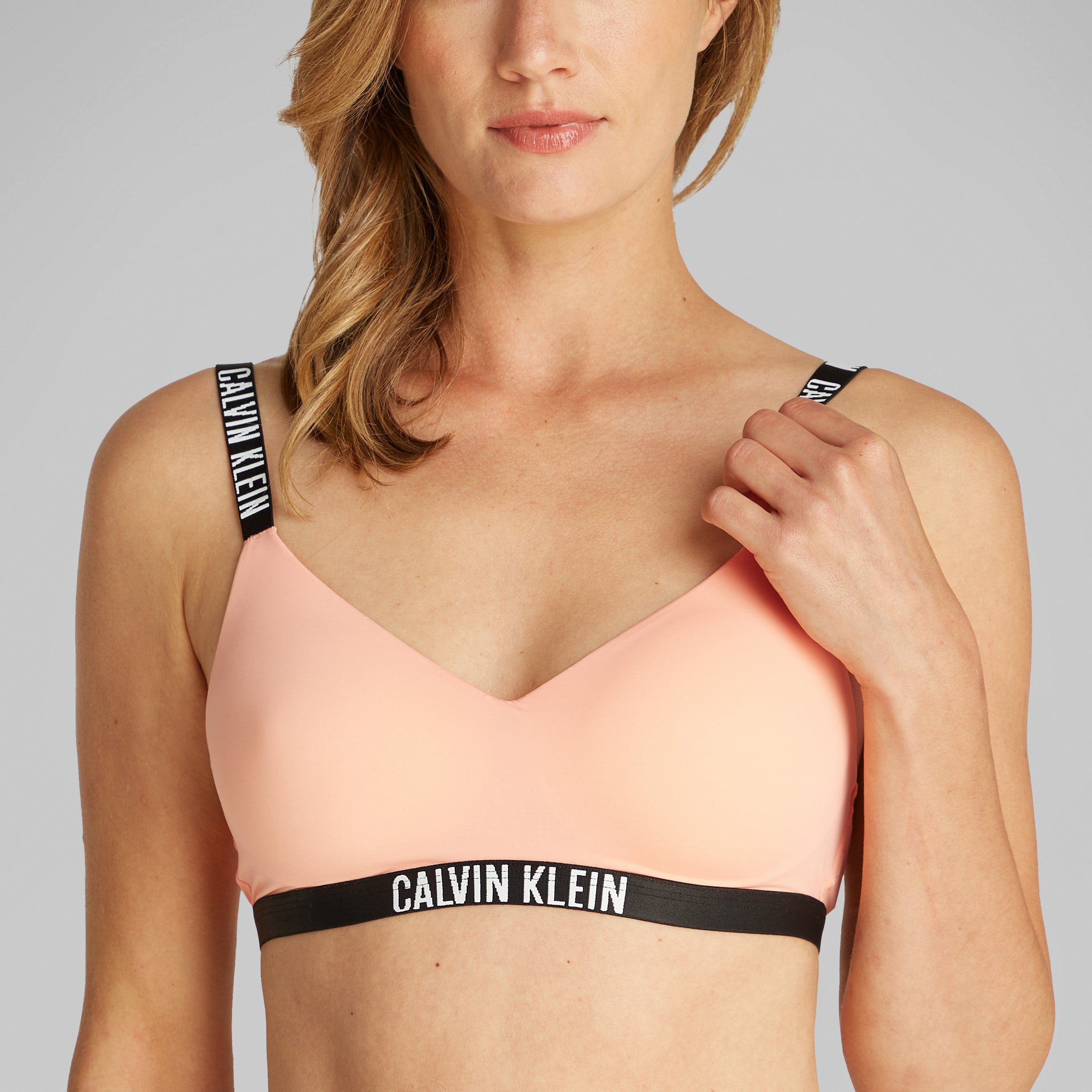Calvin Klein INTENSE POWER Womens Bralette Papaya Punch front view, featuring soft moulded cups and adjustable straps.