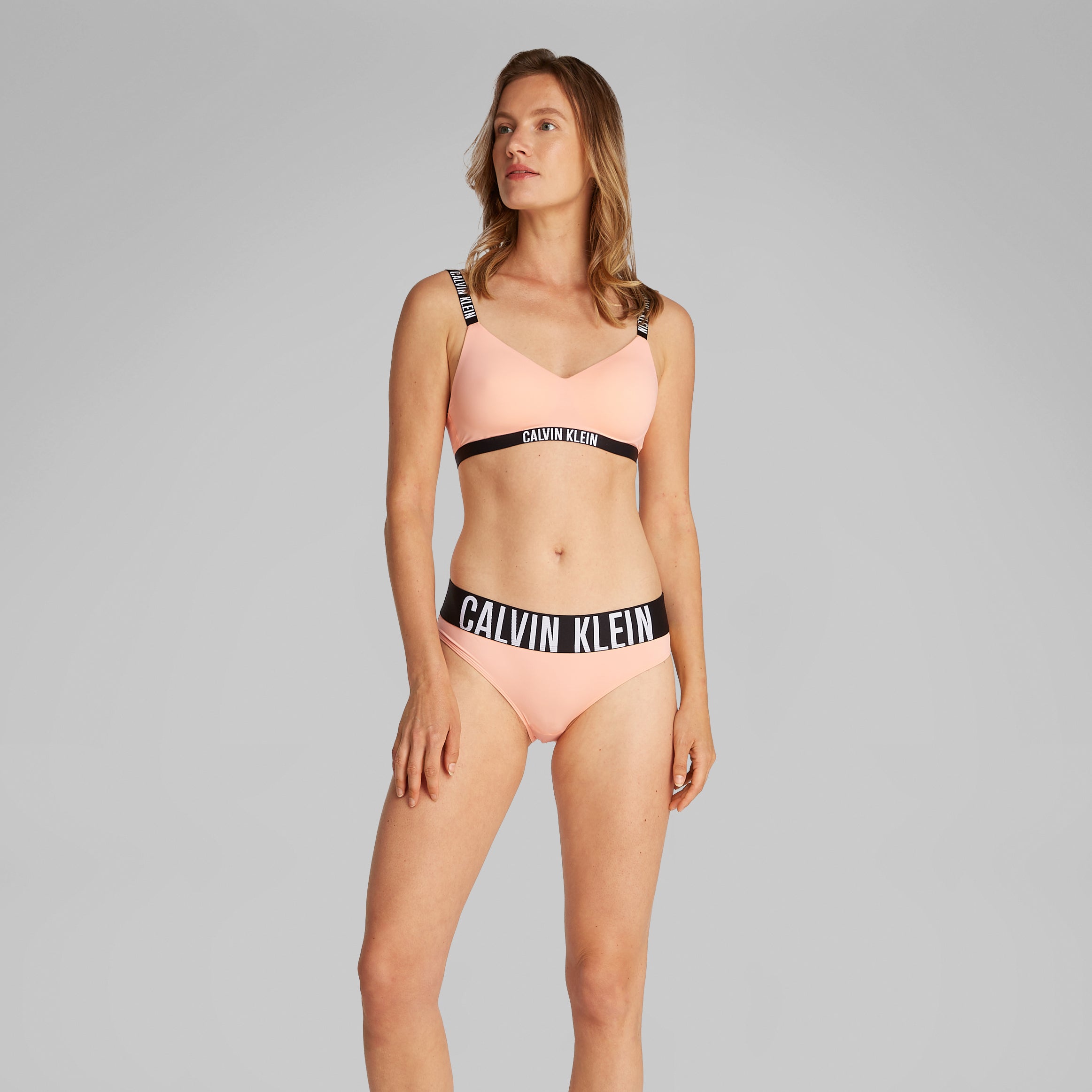 Calvin Klein INTENSE POWER Womens Bikini Briefs Papaya Punch front view on model with CK signature elastic waistband
