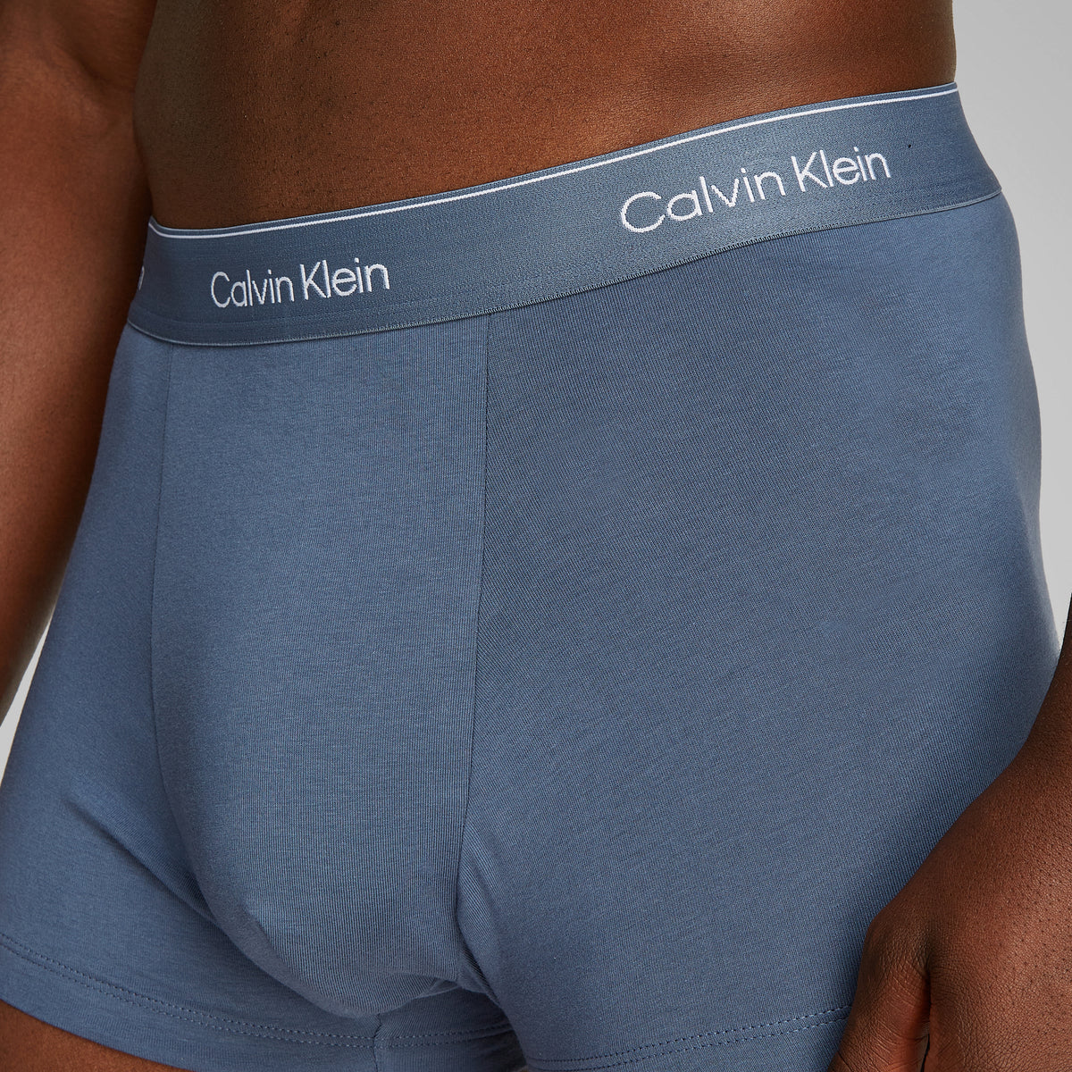 Calvin Klein ICON Cotton Stretch 3 Pack Dart Trunks Multi side view showcasing the blue trunk with CK branded waistband.