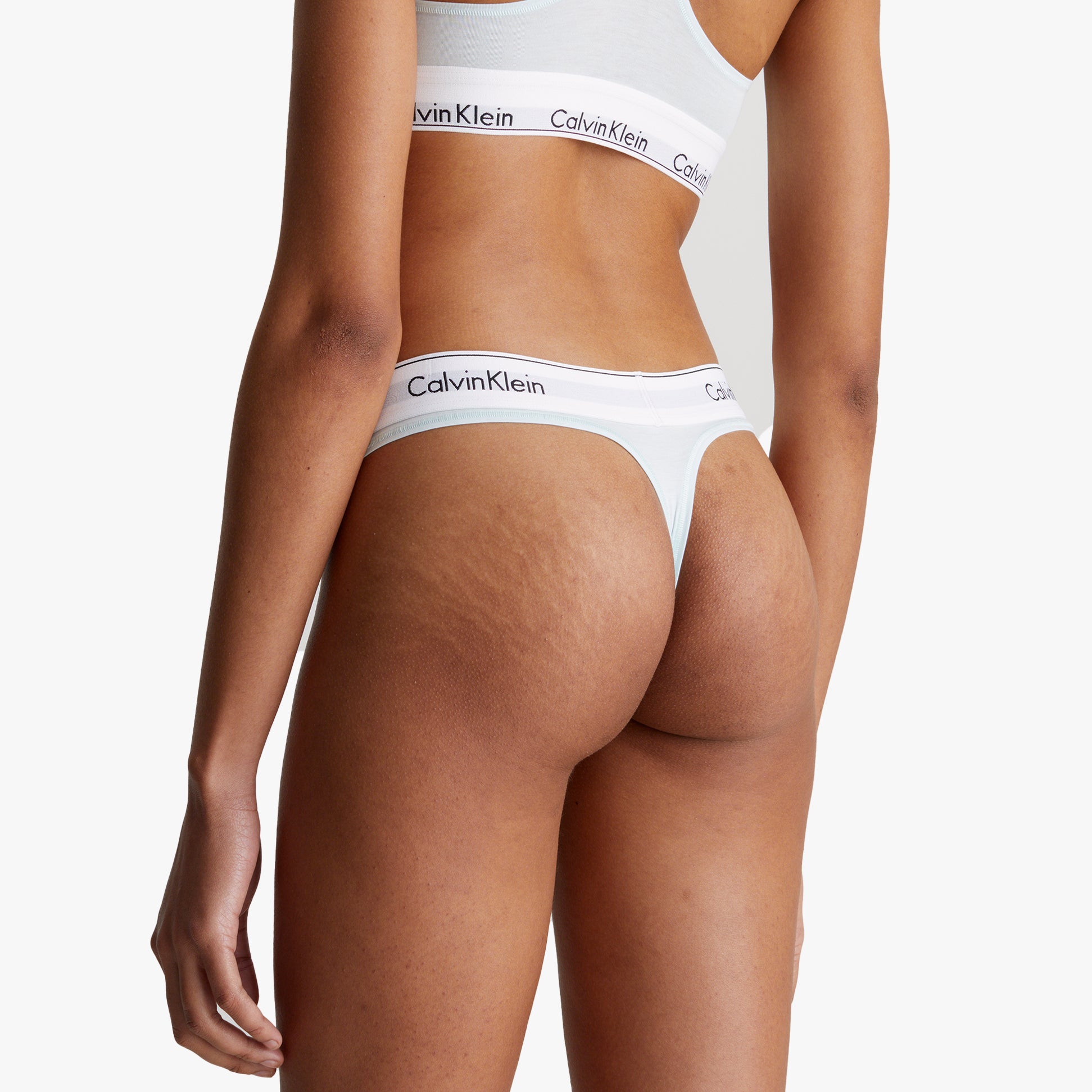 Calvin Klein MODERN COTTON Womens Thong Island Reef back view showcasing signature elastic waistband in white.