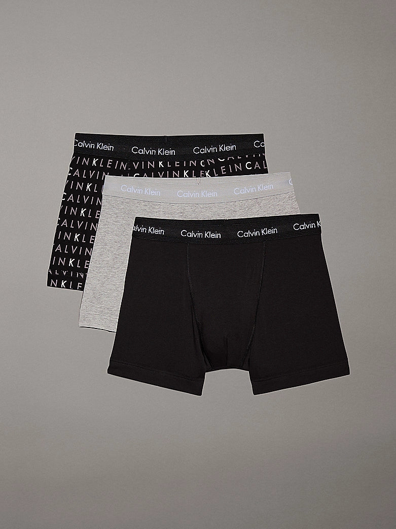 Calvin Klein COTTON STRETCH 3 Pack Mens Trunks Black Multi, front view showing three designs: black, gray, and patterned.