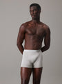 Calvin Klein COTTON STRETCH 3 Pack Mens Trunks Black Multi side view model wearing gray trunks with CK signature waistband.