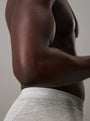 Calvin Klein COTTON STRETCH 3 Pack Mens Trunks Black Multi side view showing grey waistband on a model.
