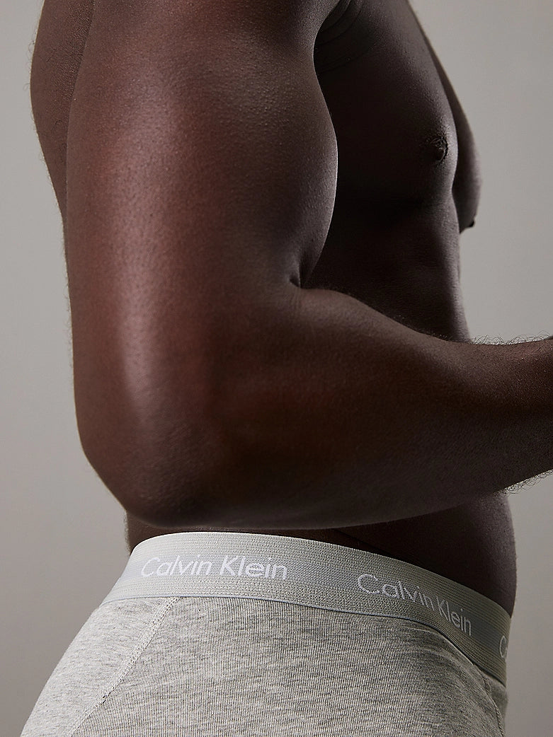 Calvin Klein COTTON STRETCH 3 Pack Mens Trunks Black Multi side view showing grey waistband on a model.