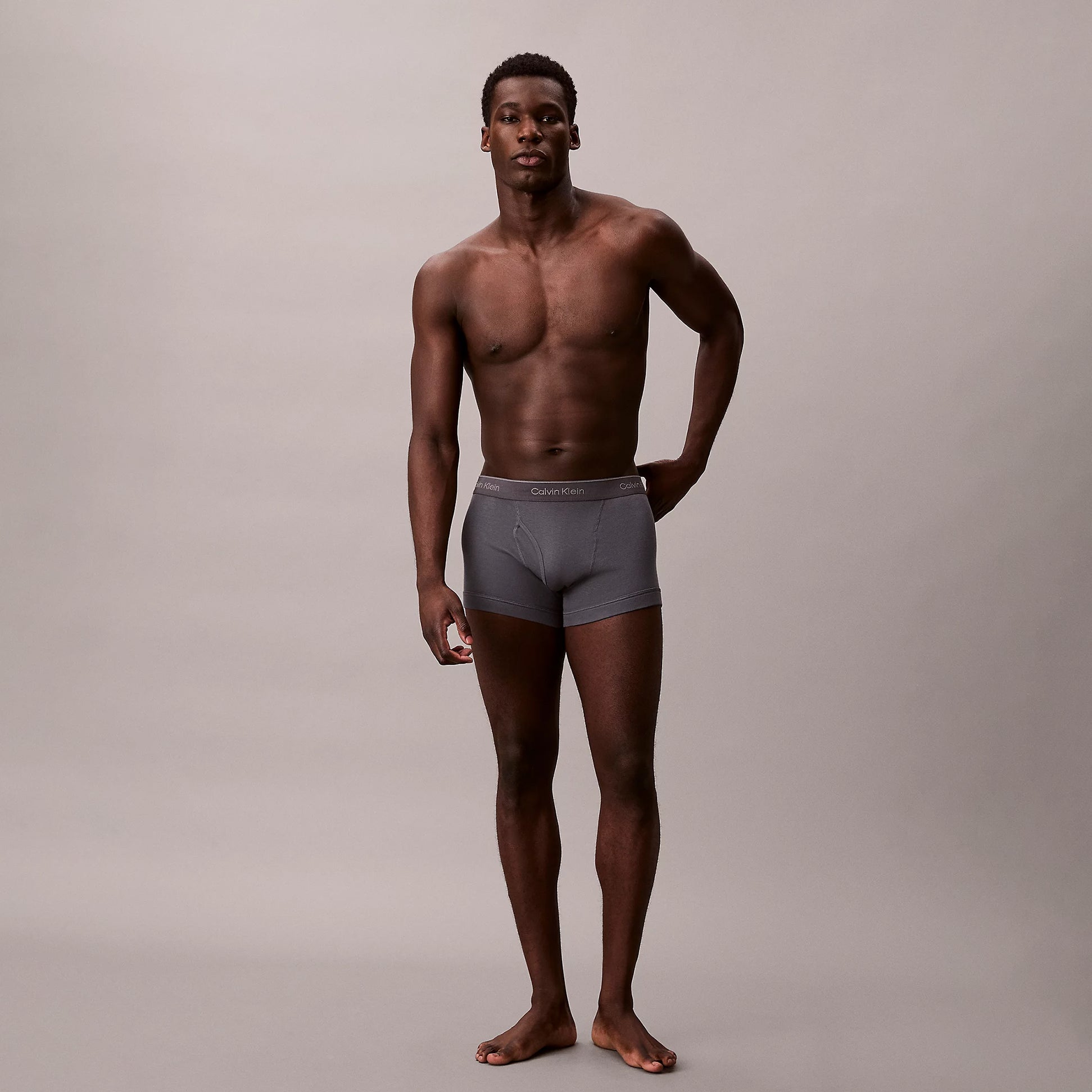 Calvin Klein TRUNK 3 Pack Mens Cotton Classics Multicoloured front view model wearing grey trunk underwear.