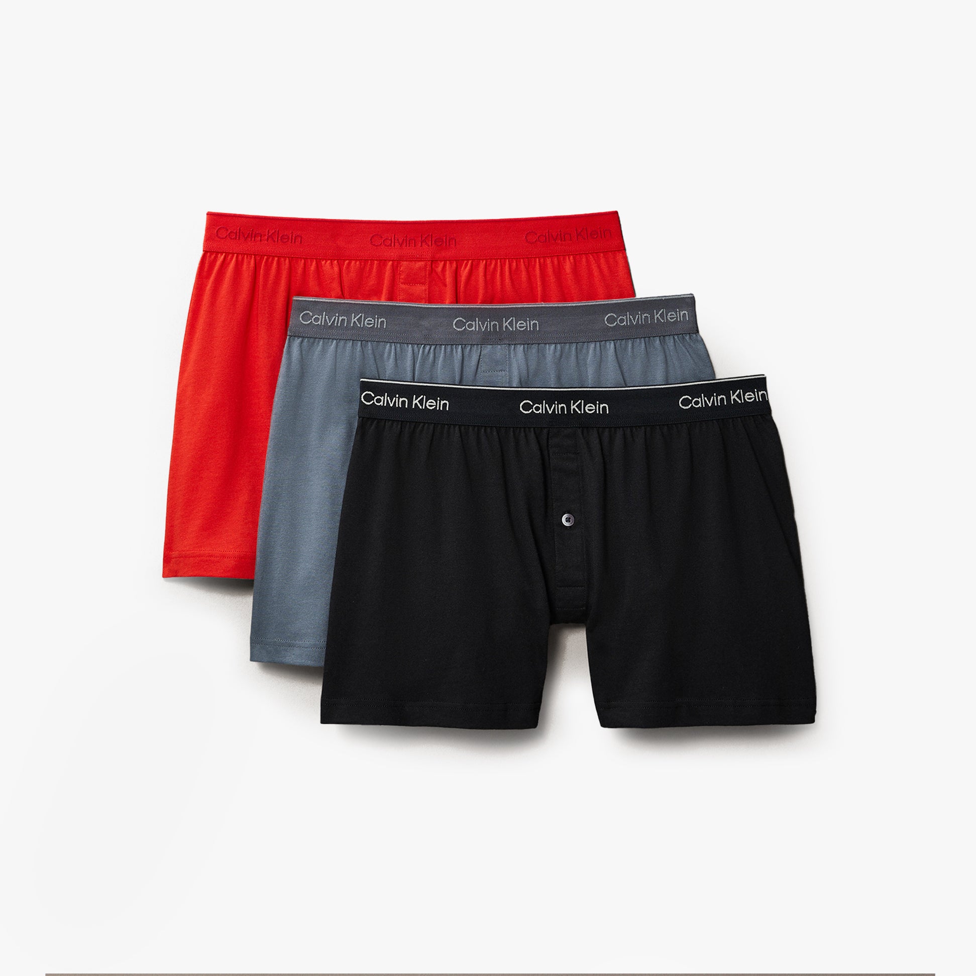 Calvin Klein 3 Pack Mens Knit Boxers Multicoloured, front view showcasing red, grey, and black boxers with branded waistbands.