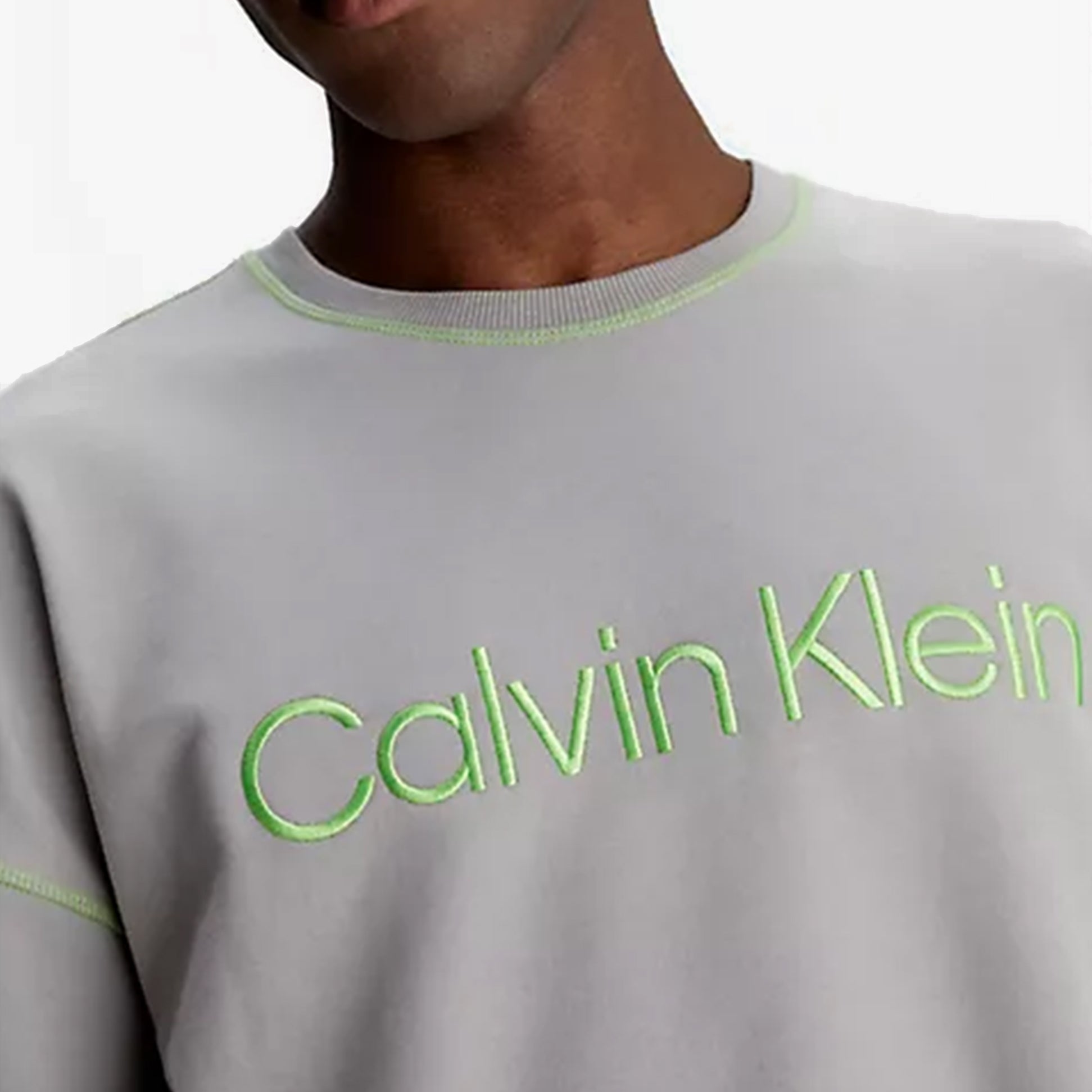 Calvin Klein FUTURE SHIFT Mens Sweatshirt Satelite detail view featuring logo embroidery in green on gray fabric.