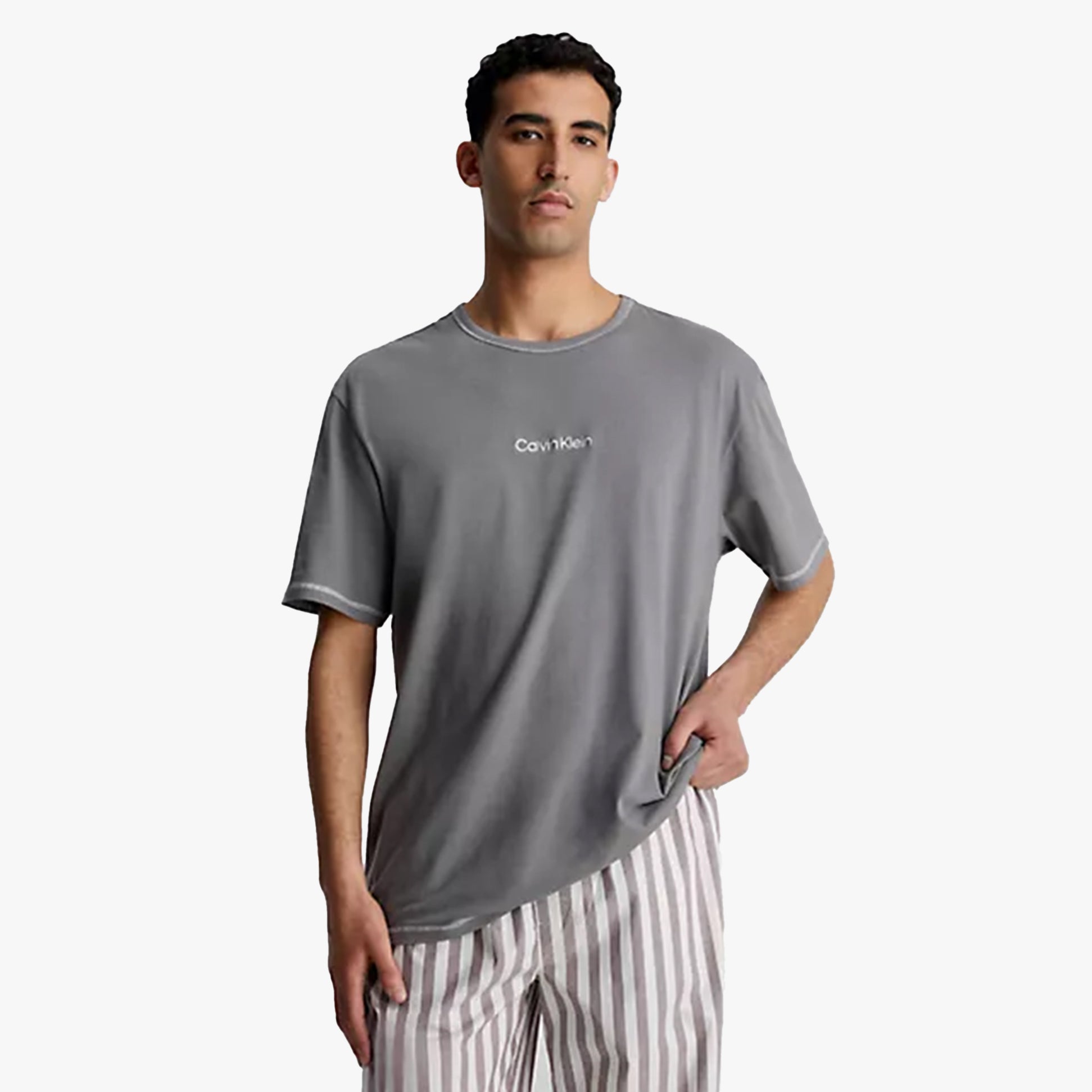 Calvin Klein FUTURE SHIFT Mens Lounge Crew Neck T-Shirt Grey front view on model with striped pants.