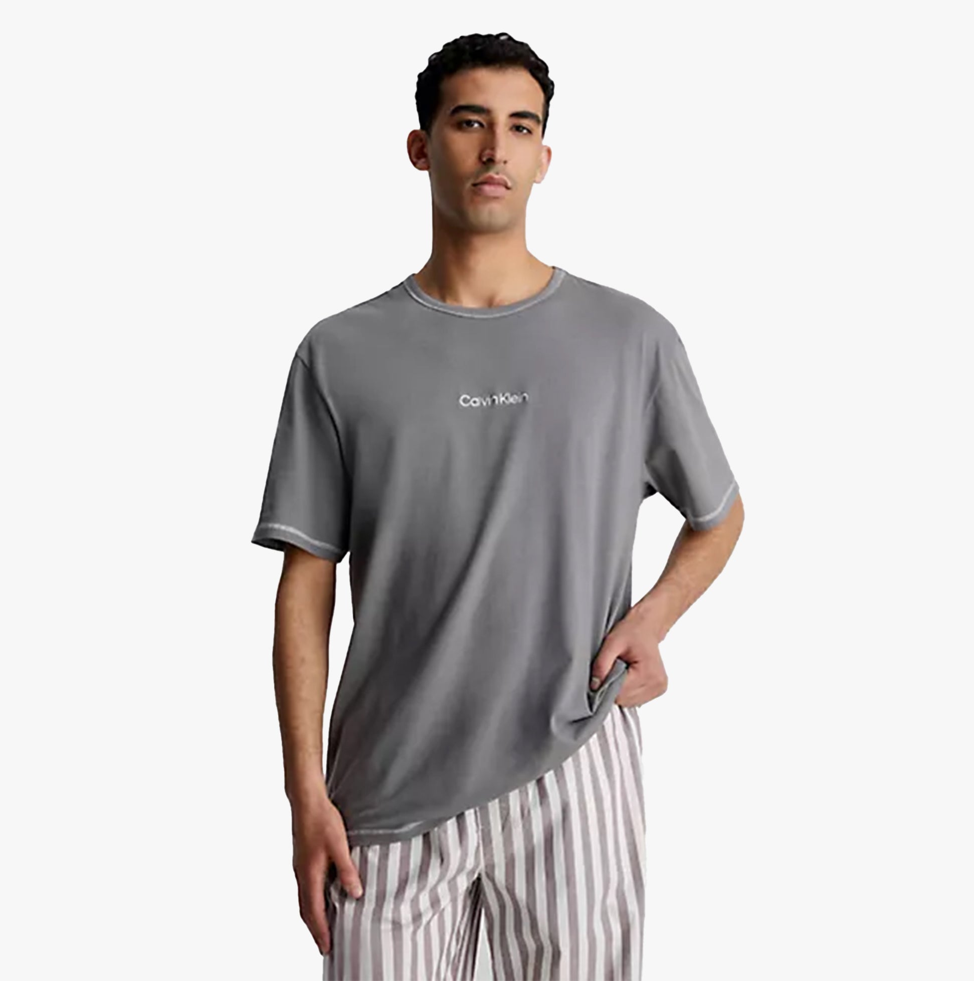 Calvin Klein FUTURE SHIFT Mens Lounge Crew Neck T-Shirt Grey front view on model with striped pants.