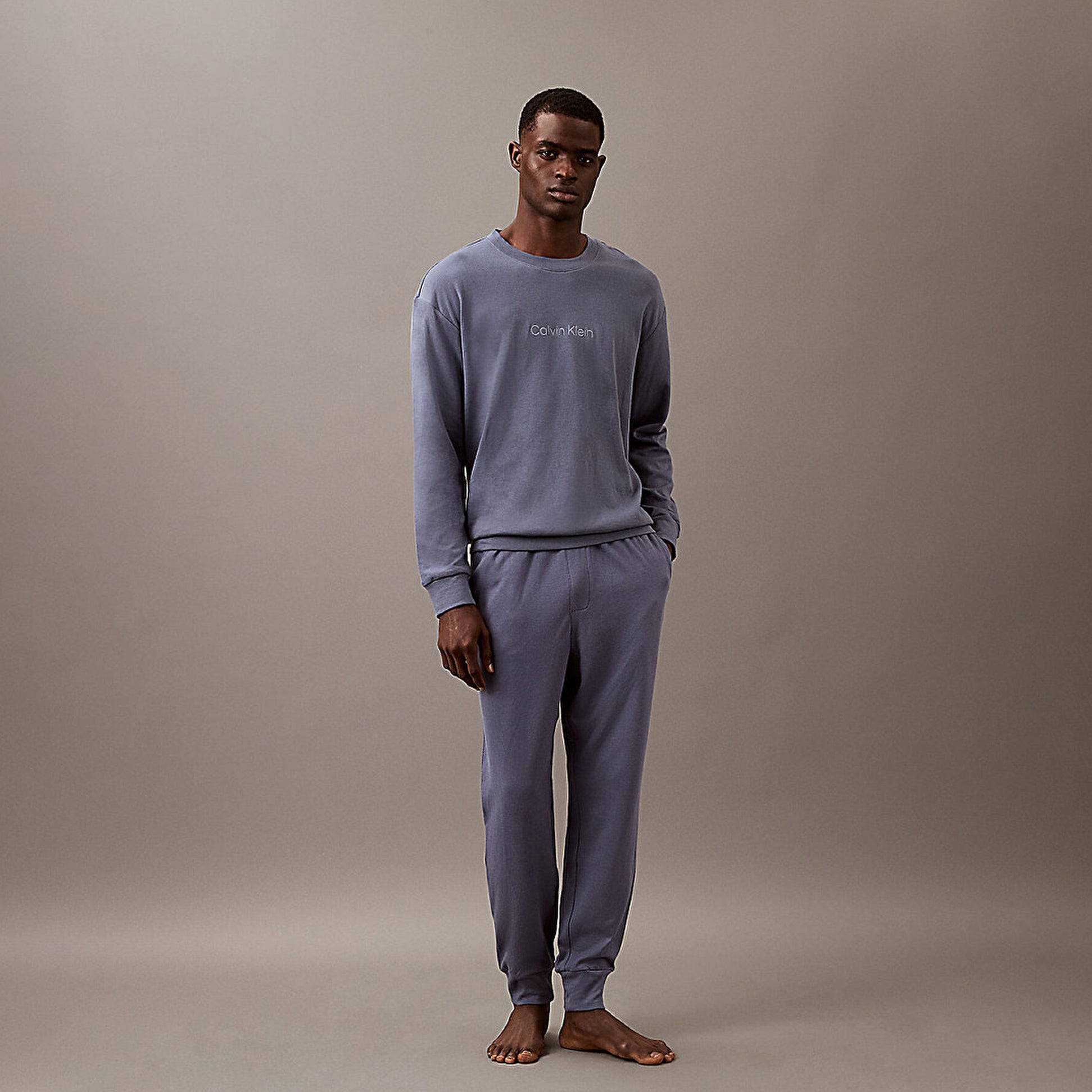 Calvin Klein ICON COTTON TERRY Mens Lounge Joggers Grisaille front view worn by a man, showcasing comfort and style.