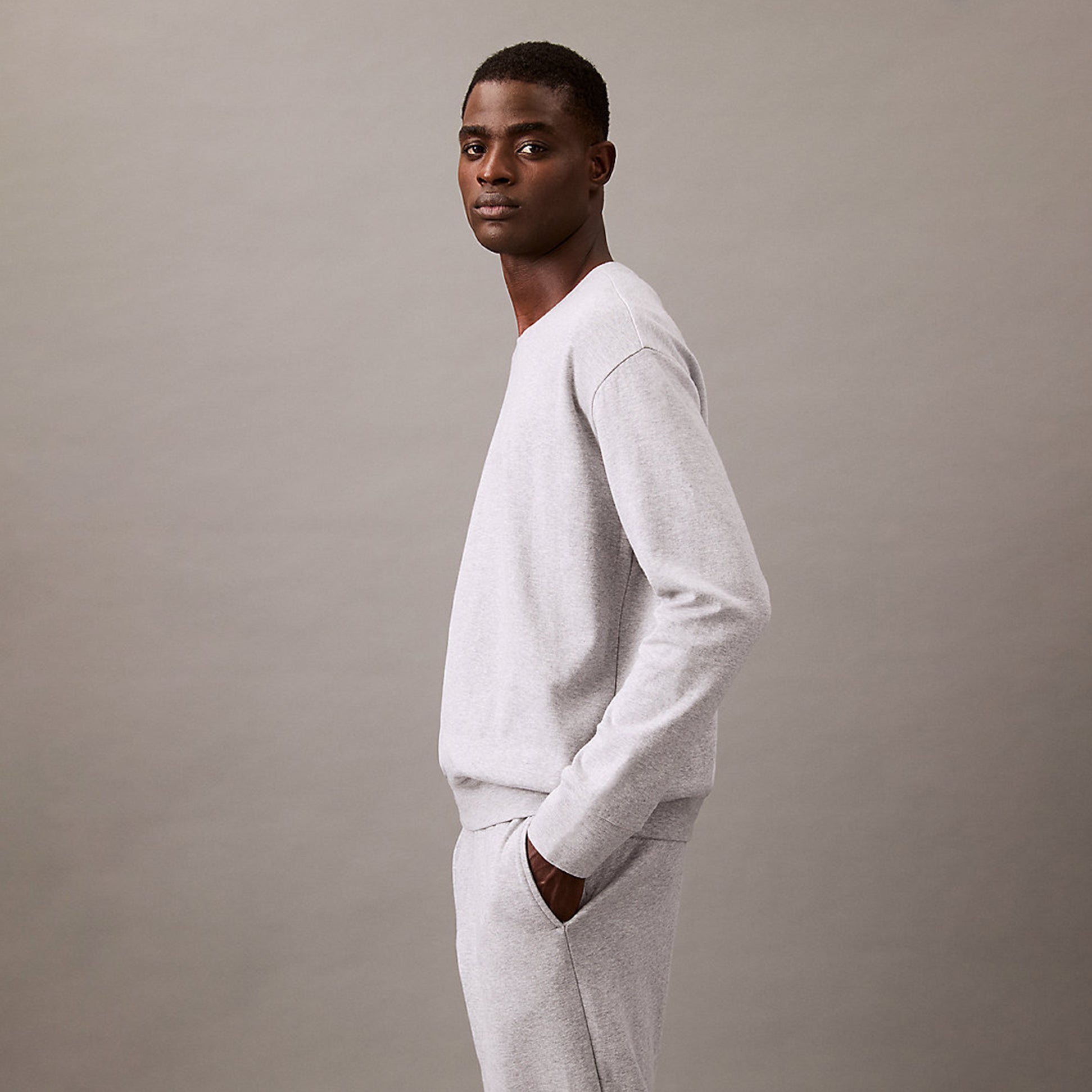 Calvin Klein ICON COTTON TERRY Mens Sweatshirt Medium Grey Heather side view model wearing sweatshirt.
