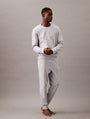 Calvin Klein MODERN TERRY Mens Sweatshirt Grey Heather front view on model standing, showcasing casual style.