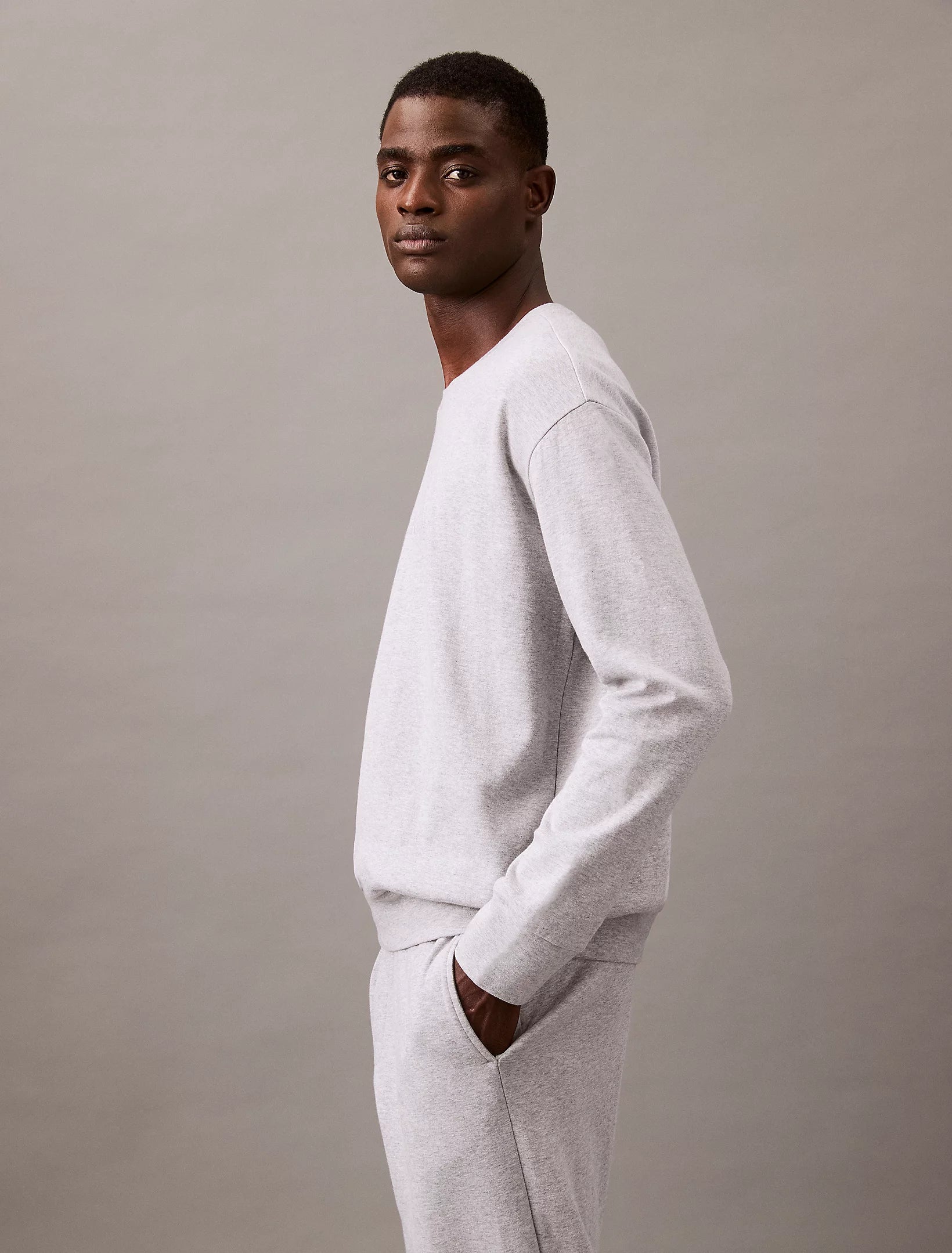 Calvin Klein MODERN TERRY Mens Sweatshirt Grey Heather side view, showcasing soft fabric and relaxed fit.