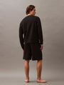 Calvin Klein MODERN TERRY Mens Sweatshirt Black back view on model, showcasing its comfortable fit and design.