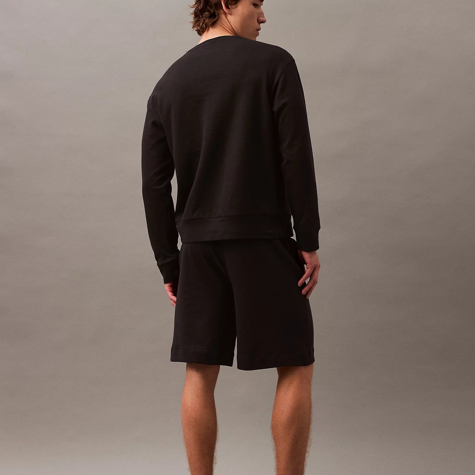 Calvin Klein MODERN TERRY Mens Sweatshirt Black back view on model, showcasing its comfortable fit and design.