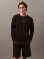 Calvin Klein MODERN TERRY Mens Sweatshirt Black front view worn by model with black shorts.