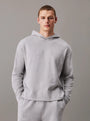 Calvin Klein ICON COTTON TERRY Mens Hoodie Grey front view with model wearing it, showcasing comfort and relaxed fit.