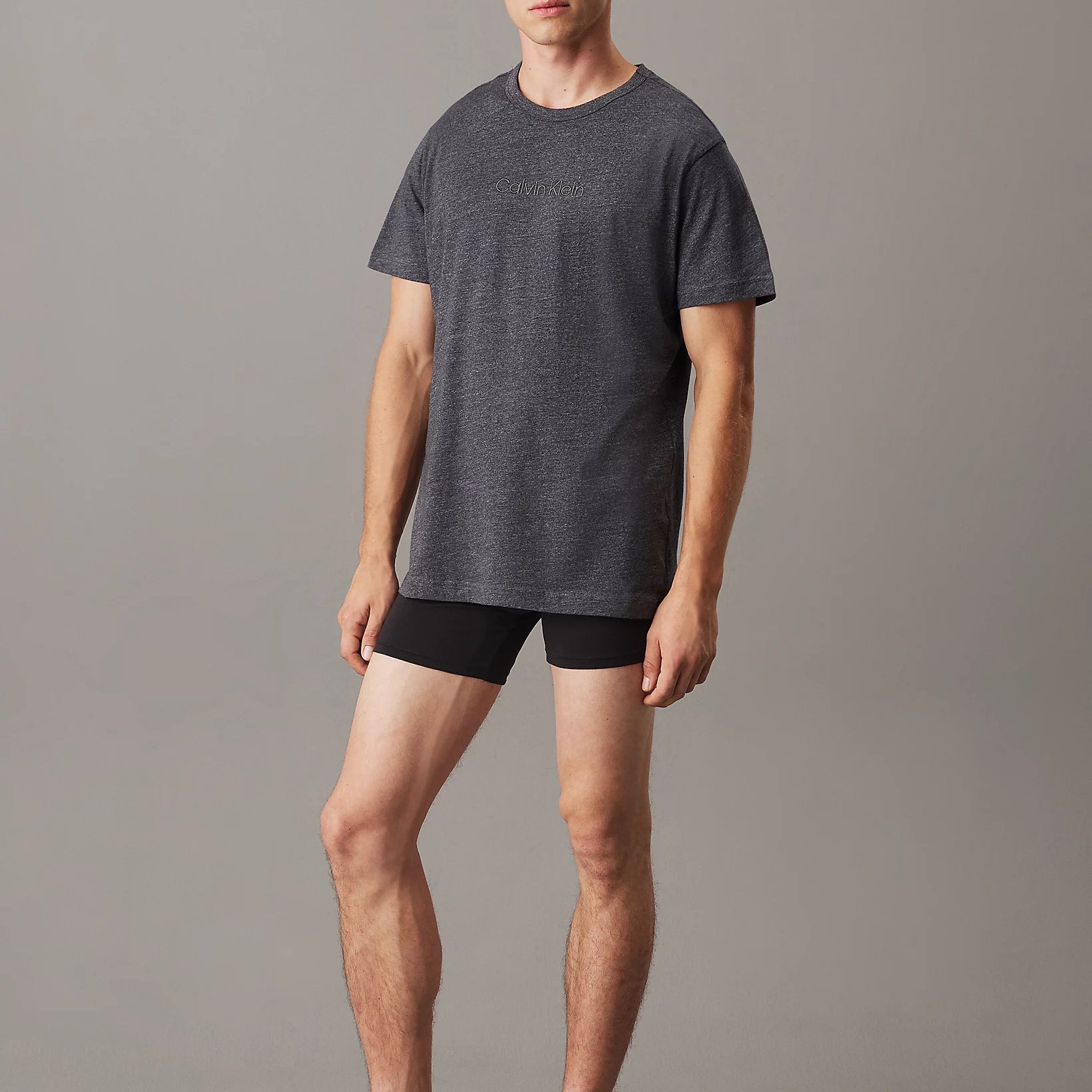 Calvin Klein LOGO COTTON Mens Crew Neck T Shirt Dark Grey Heather front view model wearing the shirt with black shorts.