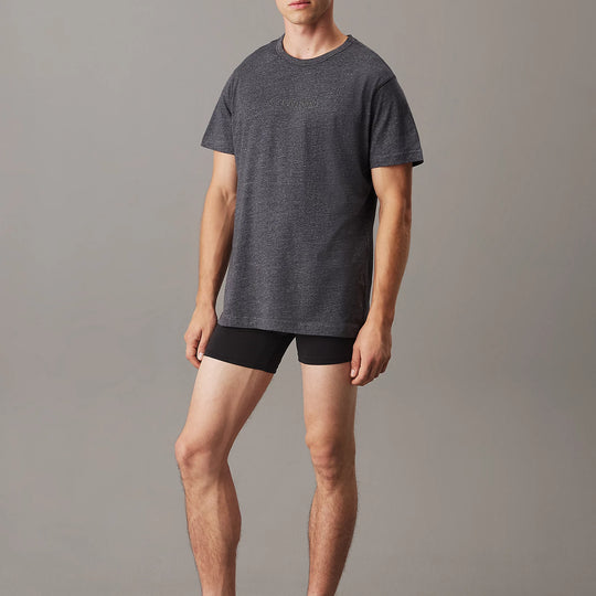 Calvin Klein LOGO COTTON Mens Crew Neck T Shirt Dark Grey Heather front view model wearing the shirt with black shorts.
