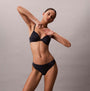 Calvin Klein Womens Invisible 3 Pack Thong Multi in black worn by model showing front view with smooth silhouette.