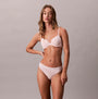 Calvin Klein Womens Invisible 3 Pack Thong Multi front view on model, showcasing comfort and fit in soft pink color.